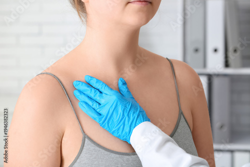 Doctor examining mole of yo...