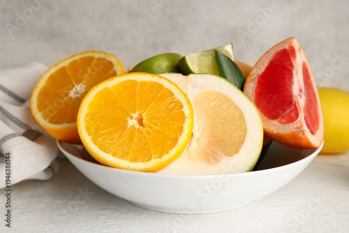 Bowl with tasty citrus frui...
