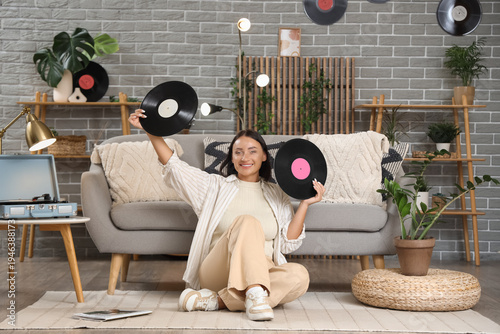 Young woman with vinyl disk...
