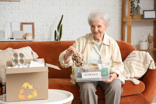 Senior woman sorting trash ...