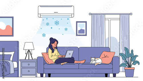 Young woman relaxing on a sofa and working on her laptop in a cool living room with the air conditioner blowing snowflakes.