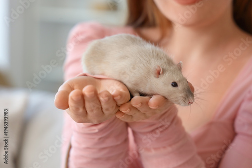 Young woman with cute rat a...