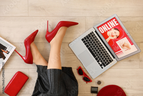 Stylish woman with laptop a...