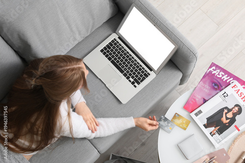 Young woman with laptop and...