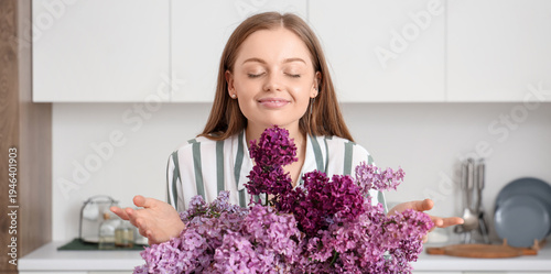 Young woman with vase of li...