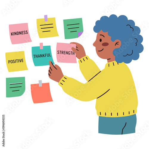 A woman sticks colorful sticky notes with positive words on a wall.