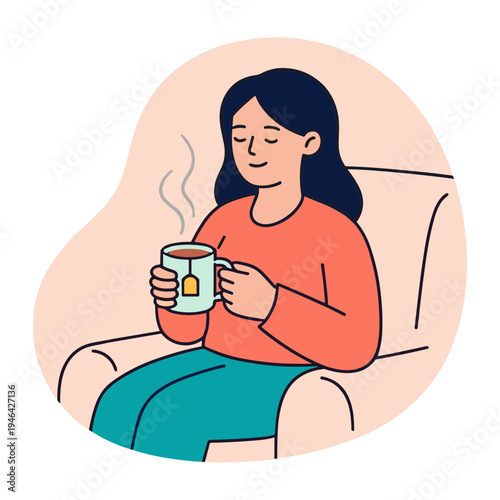 Woman sits on couch sipping hot beverage with steam rising