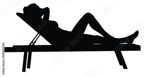 A woman relaxes on a lounge chair in a peaceful setting.