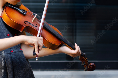 A young girl plays the violin with focus and grace, capturing the beauty of music education. Creativity, passion, and early artistic growth.