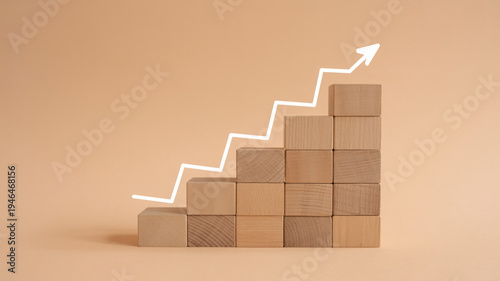 Wooden Blocks Stacked In Staircase Formation With White Line Graph And Arrow On Beige Background For Business Growth Concepts