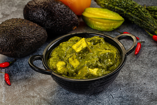 Tablou pe pânză Palak Paneer, an Indian spinach and cottage cheese curry, served in a bowl with fresh vegetable ingredients
