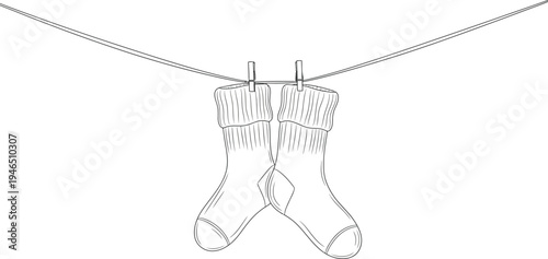 A pair of socks hanging on a clothesline with a clip