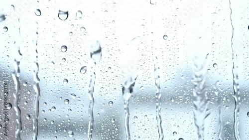 Raindrops Flowing Down Window Glass in Slow Motion