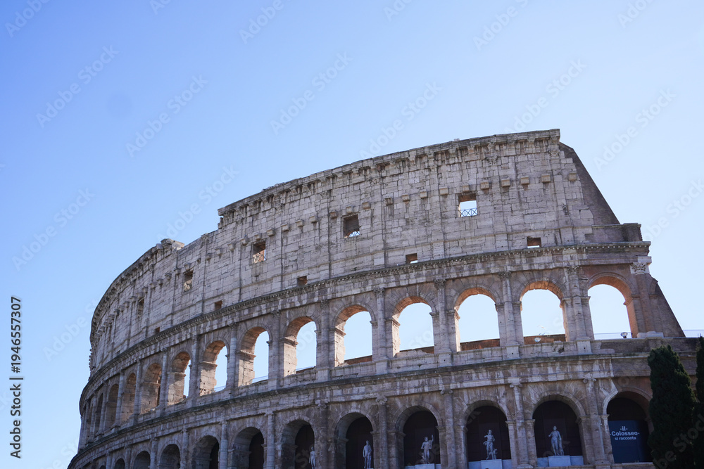 Obraz premium Colosseum (Coliseum) building or Flavian Amphitheatre in Rome, Lazio, Italy. Architectural monument of Ancient Rome. Close up view of the Colosseum, highlighting arches and aged stone. 