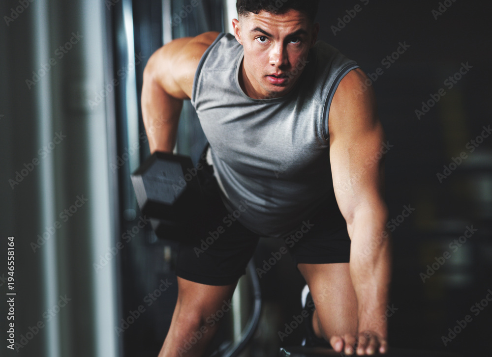 Obraz premium Portrait, weightlifting or man in fitness center with dumbbell, power or bicep curl in bodybuilding. Exercise, strength training or athlete with equipment, intense workout or challenge in muscle gain