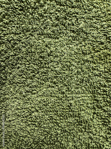 Photos Close-up green towel texture with soft terry cloth loops and detailed textile surface