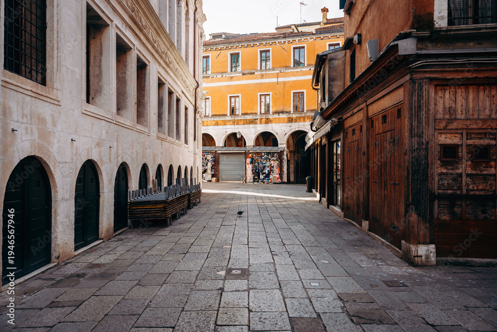 Fototapeta premium Street view in an old town with shops and empty benches in the morning light