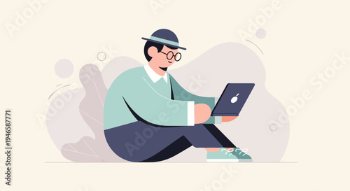 A person in a hat and glasses sits cross-legged with a laptop