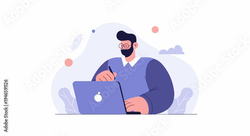 A man wearing glasses and a beard works on a laptop in a creative setting