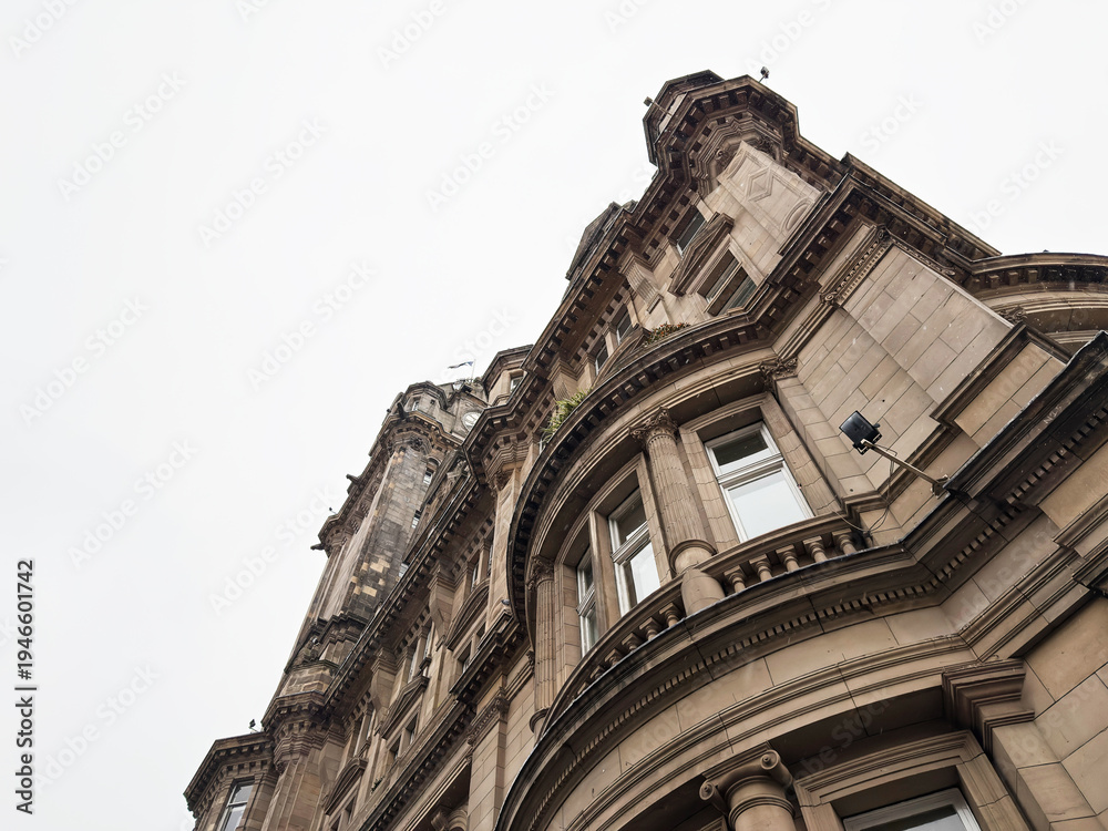 Fototapeta premium Ornate Victorian stone building facade and classical architecture in Edinburgh, Scotland, UK with dramatic upward perspective