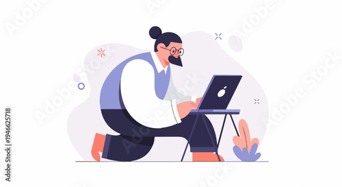 A person with a bun and glasses kneels, working on a laptop on a stand