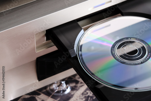 a music compact disc in the open slot of a disc player