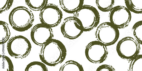 Scattered olive green brush stroke circles on white background