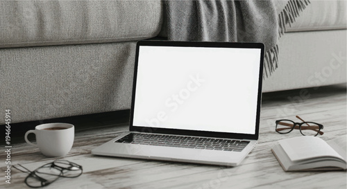 A cozy workspace setup with a laptop, coffee, and reading materials on a couch.