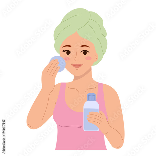 Skincare routine concept. Young woman with towel on head cleaning face with cotton pad and micellar water bottle. Female removing makeup during daily facial cleansing, beauty hygiene routine isolated.