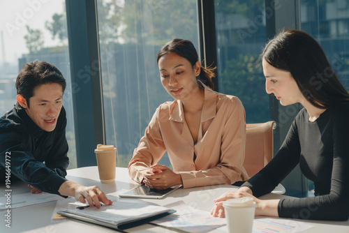 Business meeting office teamwork discussion documents coffee tablet modern professional collaboration