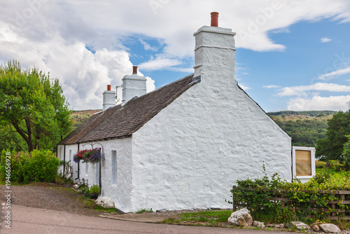Traditional whitewashed stone cottage in Scottish countryside