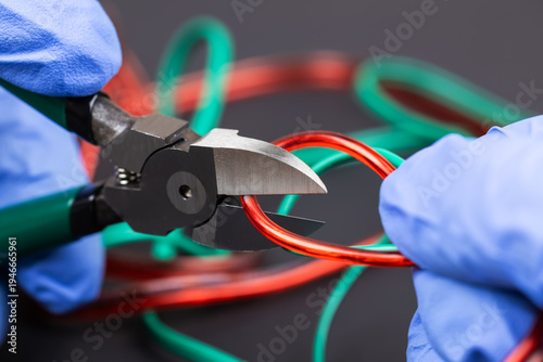 Принти на полотні Technician man cutting electrical wires with nippers repair service, and install