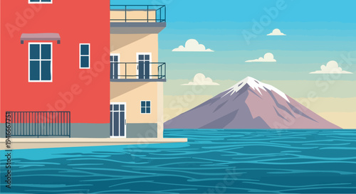 Coastal town buildings overlook sea toward majestic snow capped mountain