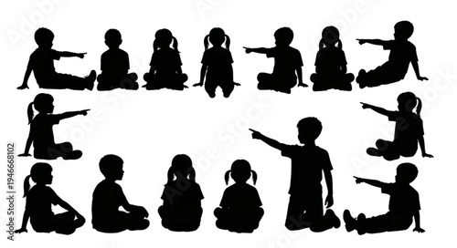 Children sitting in class pointing.