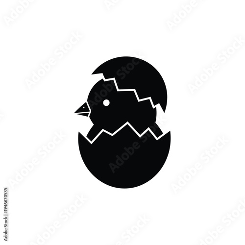 Black silhouette of a newborn chick hatching from an egg