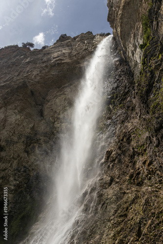 The beautiful 90m high waterfall of Cascade Saint Benoit, near Aussois, Modane, in Savoie, France. The waterfall is a popular tourist spot in the French Alps.