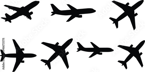 Black silhouettes of airplanes in various flying positions on white background
