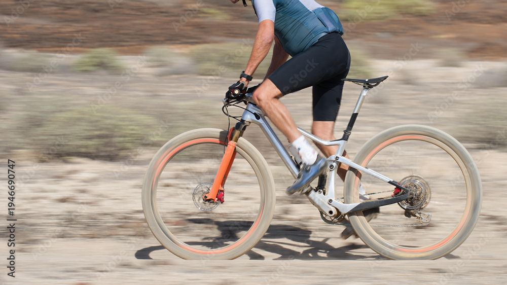 Fototapeta premium Mountain biker in action on a stone trail concept for healthy lifestyle, exercise and extreme sports.Bike panning shot