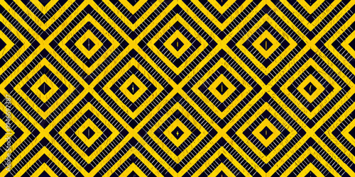 Bold yellow and black diamond pattern creates a striking geometric background