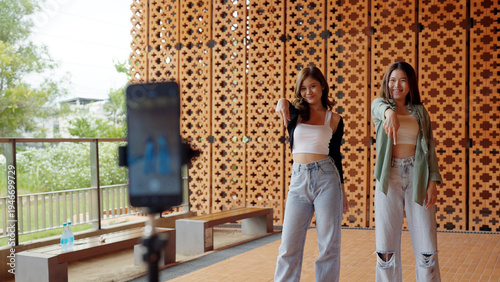 Gen z vlogger influencer asia teen girl trending relax smile moving dance at city park street record on IG reel tiktok instagram app young youtuber play fun joy selfie post show share viral vlog video