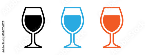 Wine glasses filled with different colored, liquids including