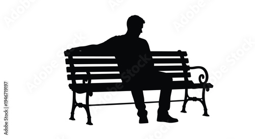 A man sits pensively on a park bench a striking silhouette