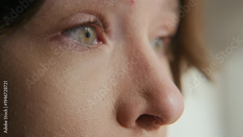 Big close up shot of young Caucasian girl with sleep deprivation squeezing her eyes shut and opening then after sleepless night