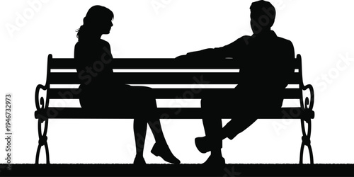 Silhouettes of a couple sitting on a park bench facing each other in a moment of quiet conversation or contemplation
