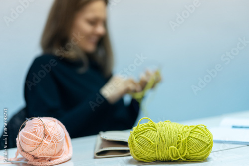 Young woman training to knit at knitting course