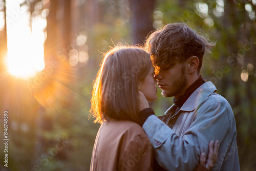 Bild auf Leinwand A loving couple hugging in the forest, a relationship crisis and separation