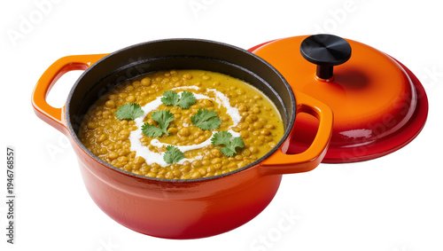 Isolated delicious hearty lentil soup or dal in vibrant orange cast iron pot and lid