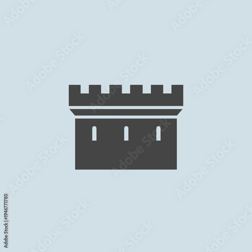 Silhouette of a castle tower with battlements and narrow windows.