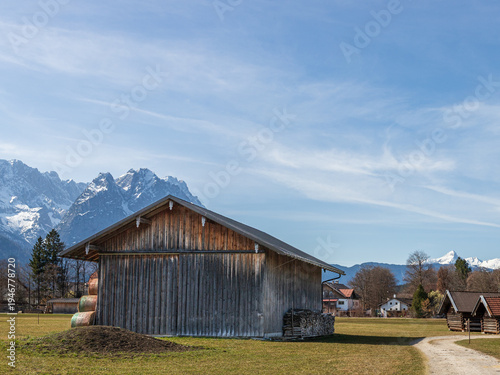 Rural barn and path with Alpine mountains in Bavaria Germany
