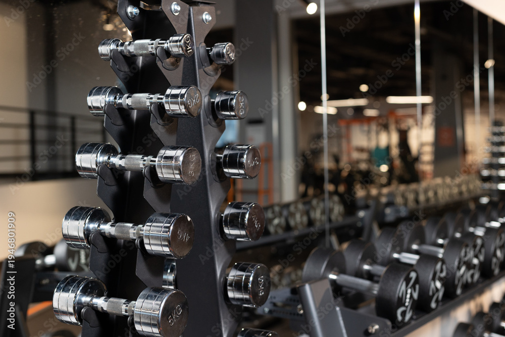 Fototapeta premium Gym equipment weights and various exercise tools, creating environment for effective workouts and strength training. Modern and clean gym interior with sport and fitness equipment, fitness center inte